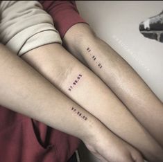 two people with matching tattoos on their arms, one has the word love and the other says