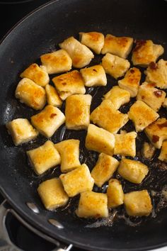 tofu is being cooked in a pan on the stove