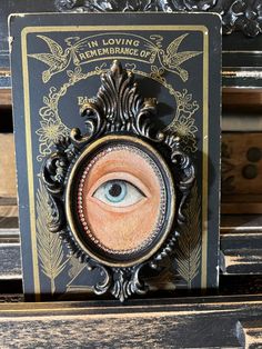 an eye is shown in the center of a card on top of a wooden table