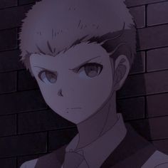 an anime character with short hair standing in front of a brick wall and looking at the camera