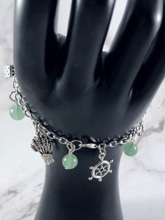 This fun, Tyche themed charm bracelet is the perfect accessory to showcase your love for the Greek Myths in a subtle way. Charms included: Ship's Wheel Coin Cornucopia Dice Wheat 5 aventurine gemstone beads are included between each charm. Comes in three sizes: Small: 6.5 inches (with extra rings at the end to expand up to 7.5 inches.) Standard: 7.5 inches Large: 8.5 inches Secures with a lobster clasp. Bracelet and charms are made with zinc alloy and beads are natural gemstones. All materials a Greek Mythology Jewelry, Mythology Jewelry, Clasp Bracelet, Greek Myths, Themed Jewelry, Greek Goddess, Tiffany Heart, Greek Mythology, Heart Charm Bracelet