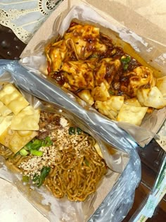 two plastic containers filled with food on top of a table