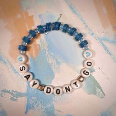 a beaded bracelet with the words saydonts written in white and blue beads