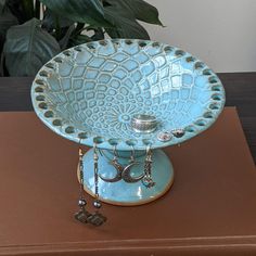 a decorative blue bowl on top of a wooden table