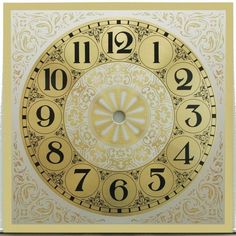 a clock with numbers on the face is shown in gold and white colors, as well as an ornamental design