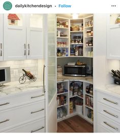 an open pantry with lots of food in it and a microwave on the counter top