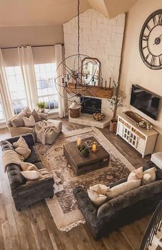 a living room filled with furniture and a large clock hanging above it's fireplace