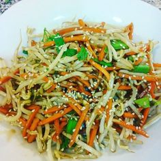 a white plate topped with veggies and sesame seeds