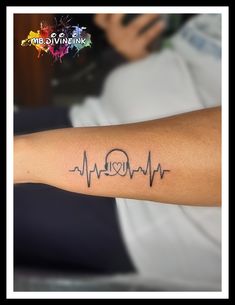 a person with a heartbeat tattoo on their arm