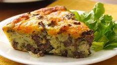 a close up of a plate of food with meat and cheese on it's crust