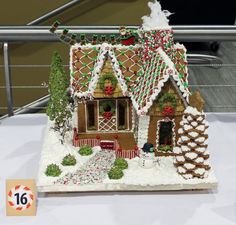 a gingerbread house is on display for people to see it's christmas decorations