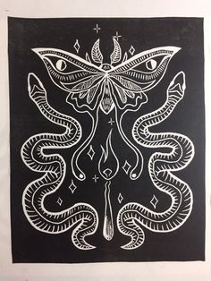 a black and white drawing of a butterfly with two snakes on it's wings