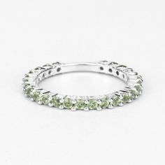 "Peridot Ring, Natural Peridot Rounds Full Eternity Band Ring in .925 Sterling Silver, August Birthstone, Engagement Ring, Promise Ring Flaunt yourself with this Peridot .925 Sterling Silver Eternity Band ring. The natural gemstones have a combined weight of 0.94 carats and are set in .925 sterling silver with rhodium plating. The green hue of this ring adds a pop of color to any look! The understated design and vibrant stones makes this ring perfect for every occasion. Product Details: .925 Ste Stackable Peridot Jewelry For Anniversary, Stackable Peridot Promise Ring, Stackable Peridot Anniversary Jewelry, Peridot Round Band Jewelry For Anniversary, Stackable Peridot Rings For Anniversary, Stackable Round Peridot Jewelry, Green Gemstone Eternity Band For Promise, Silver Peridot Ring With Round Cut, Peridot Crystal Ring For Anniversary