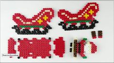 three pieces of beaded christmas decorations on a white surface, one is red and the other is green