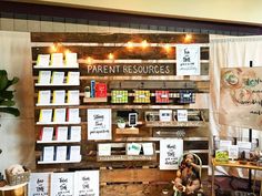 there are many books on display in the store with lights strung up above them and below it is a sign that says parent resources