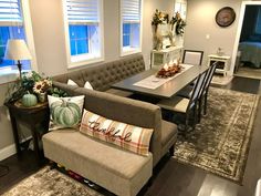 a living room filled with furniture and decor on top of a hard wood floored floor