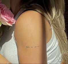 a woman with a small tattoo on her arm