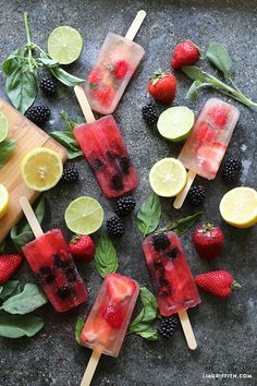 several popsicles with fruit on them and mint leaves