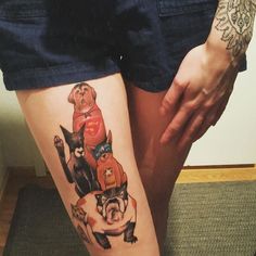 a woman's legs with tattoos on them and dogs in the middle of her leg