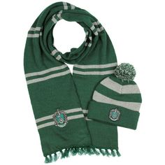 a green scarf and hat with harry potter crest on it, sitting next to each other