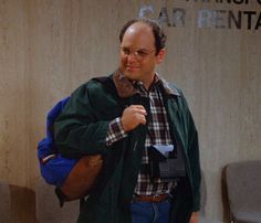 a man with a backpack is standing in front of a sign that says caring care