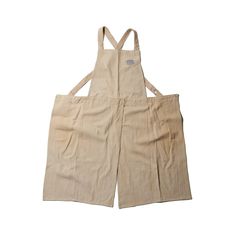 a pair of beige overalls with straps on the front and back, sitting against a white background