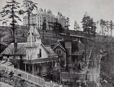 an old black and white photo of houses on a hill