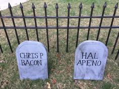 two tombstones that have been placed next to each other in front of a fence