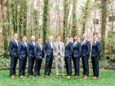 a group of men in suits standing next to each other