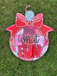 a painted ornament with the words on what fun is written in pink and red