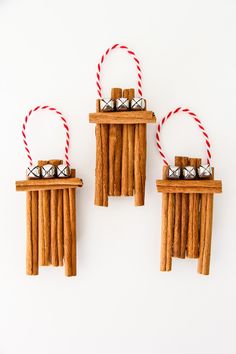 three pieces of wood with bells hanging from them