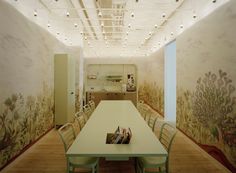 a dining room with a table and chairs in front of a mural on the wall