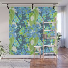 a blue and green floral wallpaper mural in a living room