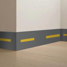 an empty room with yellow and gray stripes on the floor