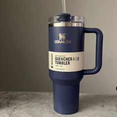 a blue travel mug sitting on top of a counter