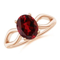 a gold ring with a red stone in the center