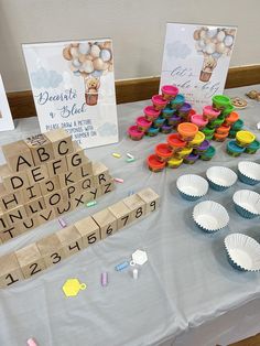 a table topped with cupcakes and scrabbles on top of it