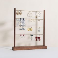 a wooden display rack with earrings on it