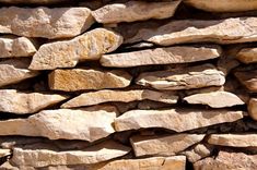 a stone wall made out of rocks and cement