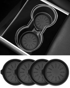 four clocks in the center of a black and white photo next to an oven door