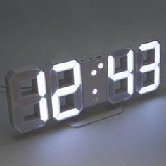 an alarm clock is lit up with the numbers 99 and nine on it's sides