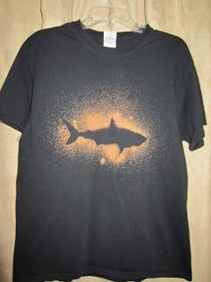 a black t - shirt with a shark on it