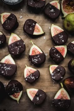 figs cut in half and placed on a cutting board next to some other fruit