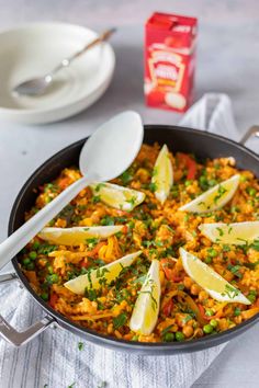 a skillet filled with rice and peas