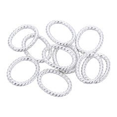 six silver colored metal rings on a white background