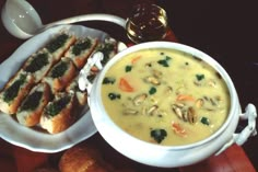 a bowl of soup and some bread on a table