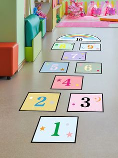 a child's playroom with numbers and toys on the floor in front of them