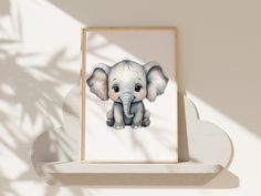 an elephant is shown in a wooden frame on a shelf next to a shadow of a plant