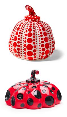 two red and white ceramic pumpkins sitting next to each other