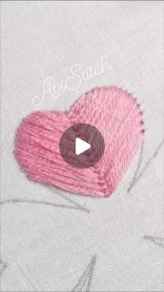 a pink heart on top of a piece of cloth with the words, fabric stitch